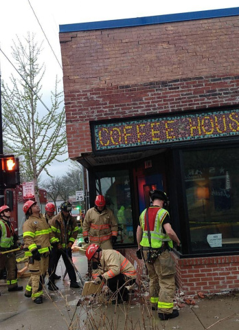 Firefighters respond to a car crash at Mother Fool's Coffeehouse.